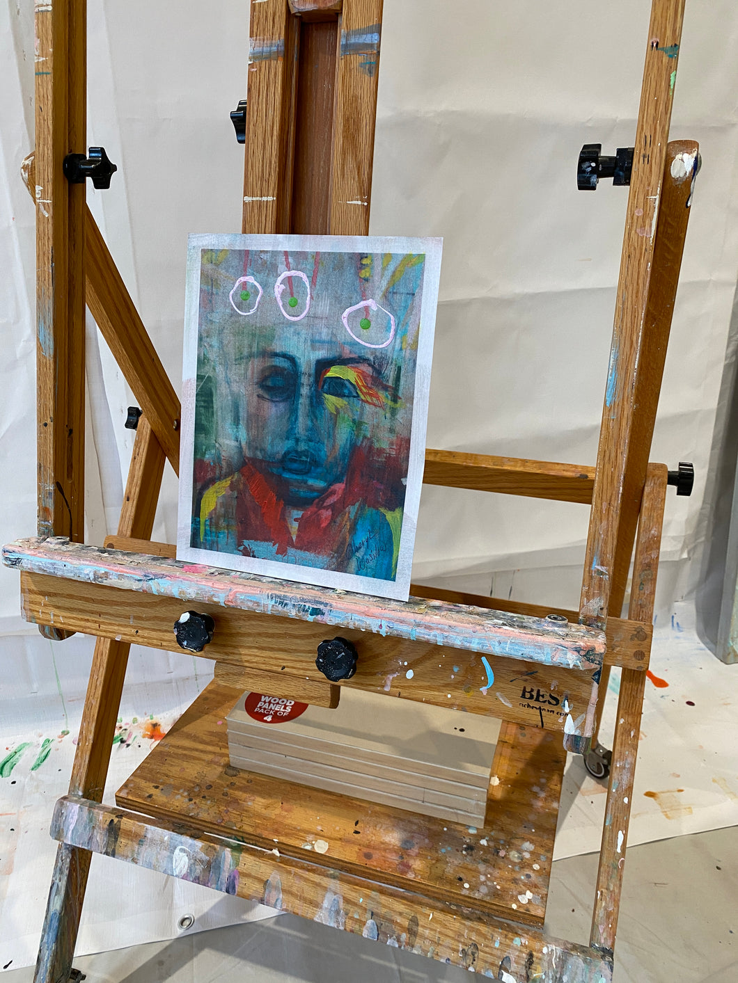Art easel with a portrait painting on a white background by artist cheryl wasilow