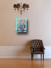 beautiful blue and pink floral painting displayed on wall in room with brown chair and brown chandelier