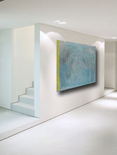 pastel blue and yellow contemporary art horizontlly on wall in modern room