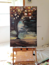 Painting of a tornado black, blue, orange and yellow on easel cherylwasilowart