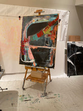 oversized black painting on easel 